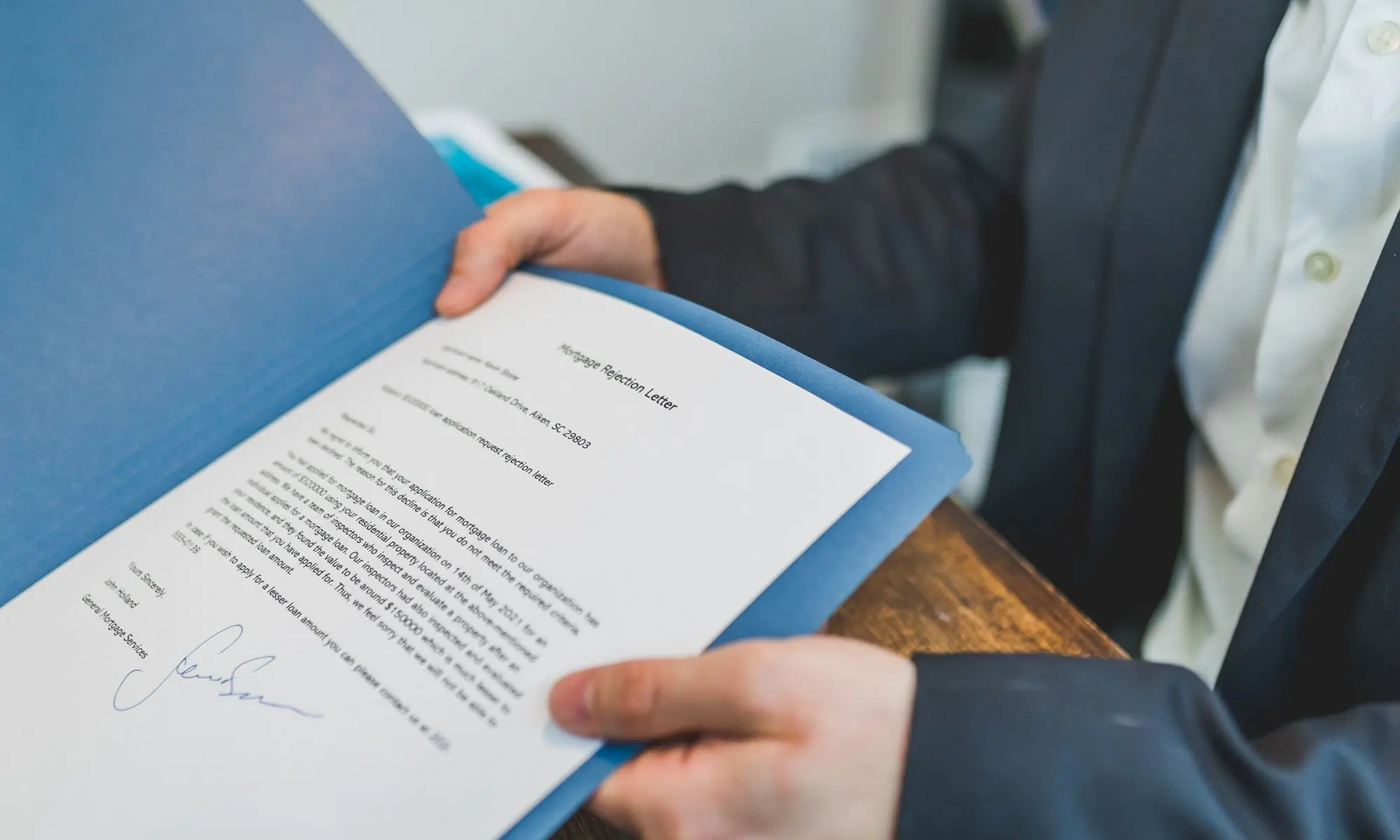 A signed housing document being reviewed in a folder
